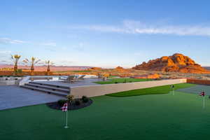 Surrounding community with a mountain view, a putting area, and a patio area