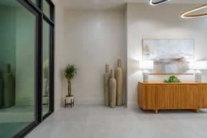 Sitting room featuring baseboards and concrete floors