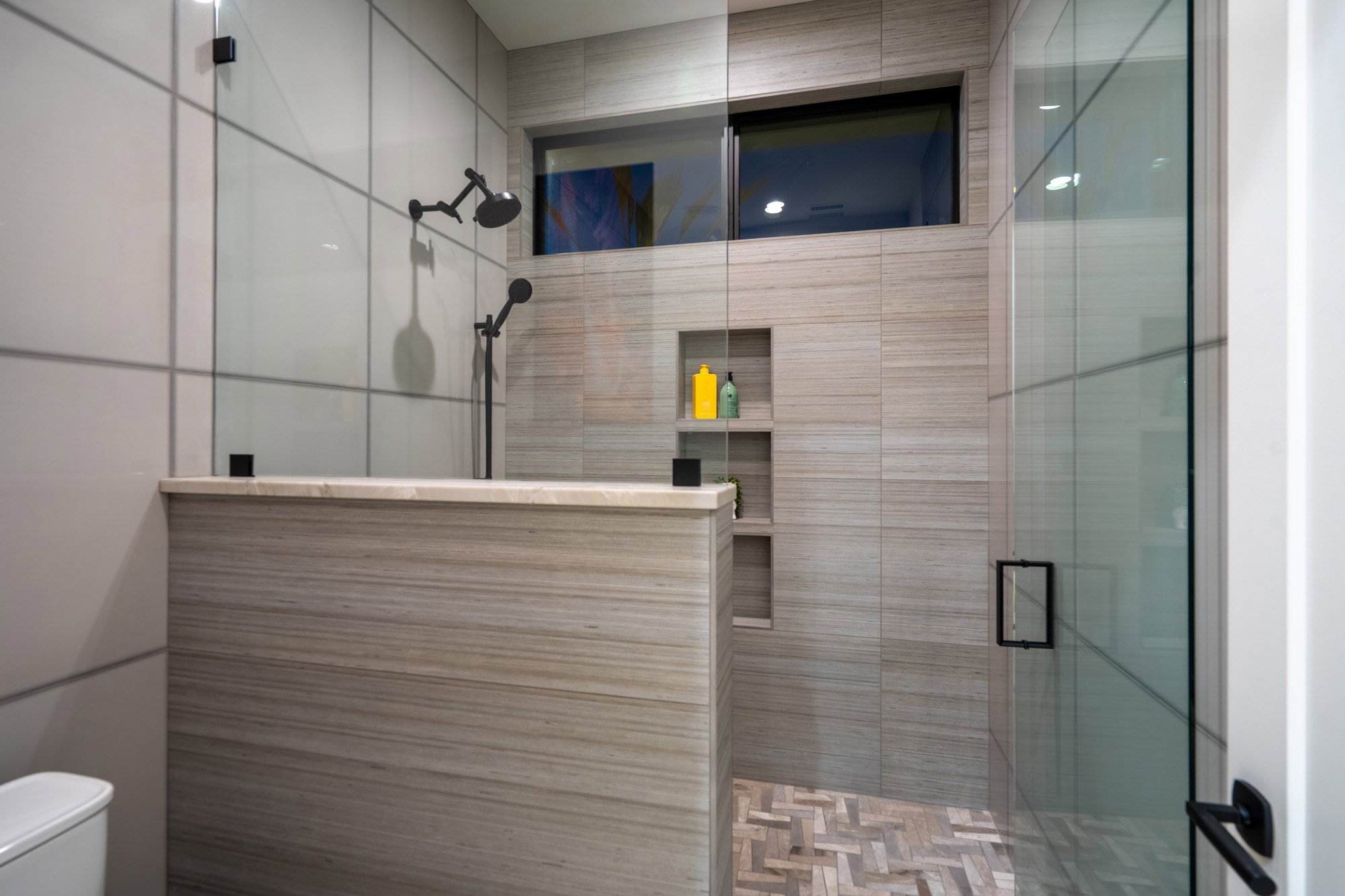 Bathroom with a stall shower and tile walls