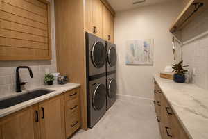 Laundry room with baseboards and cabinet space