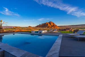 Outdoor pool with a mountain view and a patio