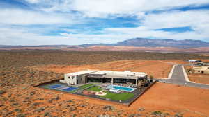 View from above of property featuring a desert landscape and a mountainous background