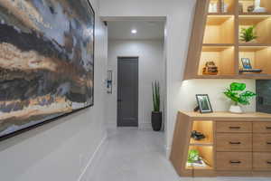 Corridor featuring recessed lighting and concrete floors