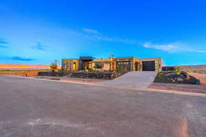 Contemporary home with an attached garage, stucco siding, and concrete driveway