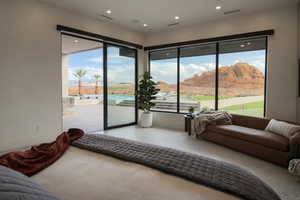 Bedroom featuring access to exterior, multiple windows, and recessed lighting