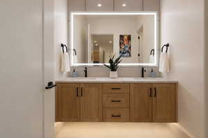Full bathroom with double vanity and recessed lighting