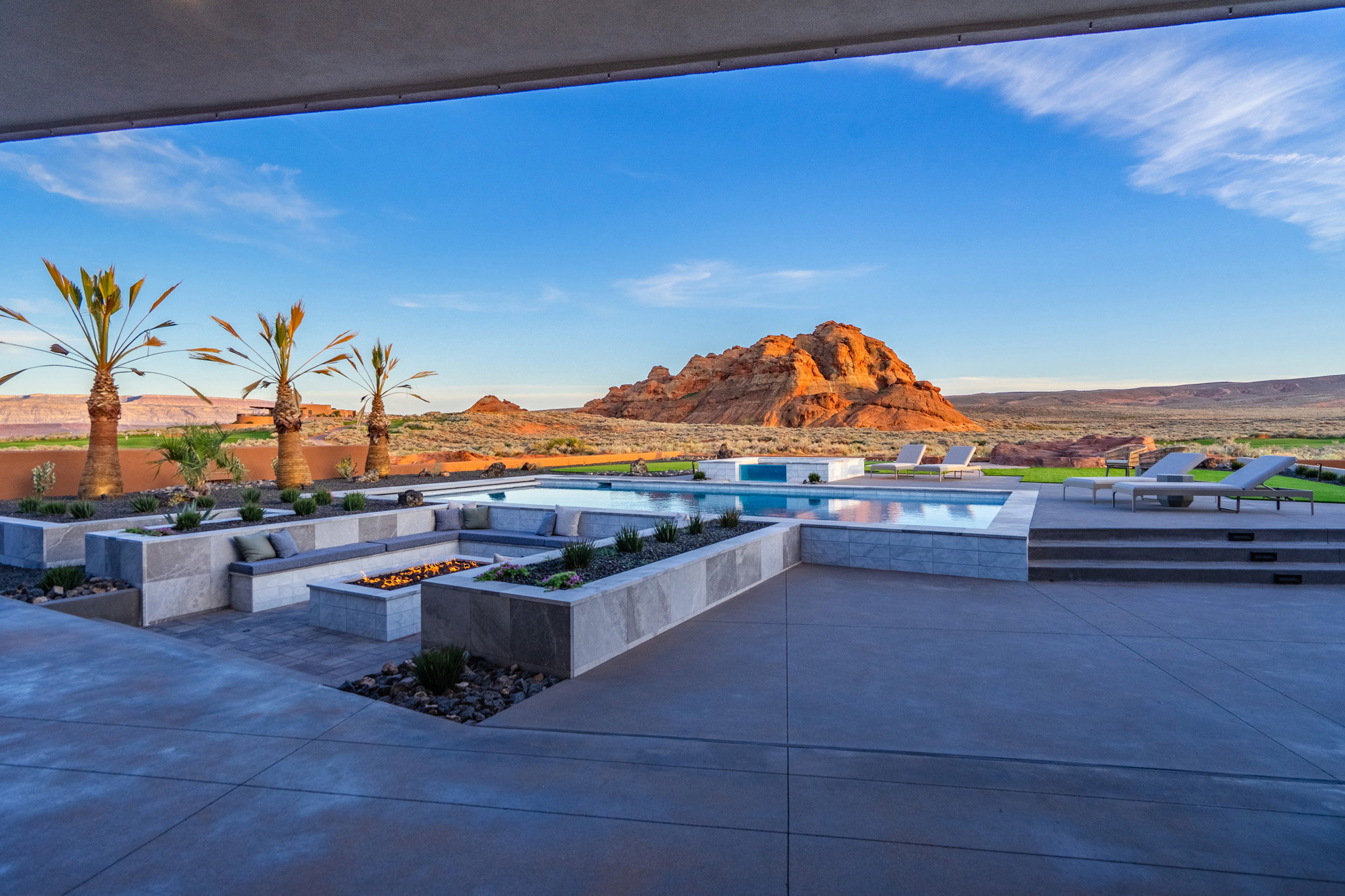 View of patio with an outdoor fire pit, a mountain view, a jacuzzi, and an outdoor pool