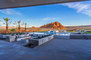 View of patio with an outdoor fire pit, a mountain view, a jacuzzi, and an outdoor pool
