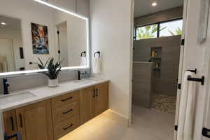 Full bathroom featuring double vanity, walk in shower, and recessed lighting