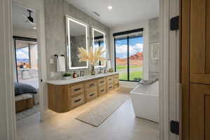 Full bathroom with double vanity, ensuite bathroom, and a soaking tub