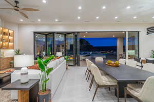 Living area with a ceiling fan and recessed lighting