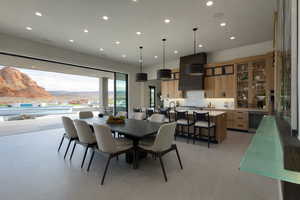 Dining room featuring a mountain view, recessed lighting, and beverage cooler