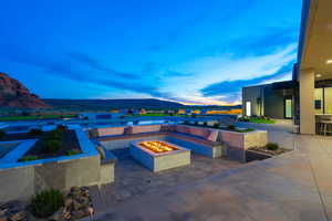 View of patio featuring an outdoor fire pit and a mountain view
