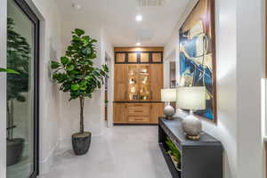 Hallway with recessed lighting and baseboards