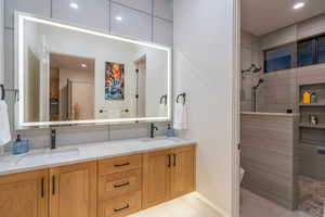 Bathroom featuring double vanity, recessed lighting, and walk in shower