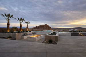 View of patio / terrace with a fire pit and a mountain view