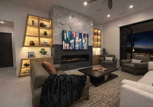 Living room featuring recessed lighting, a fireplace, and a ceiling fan