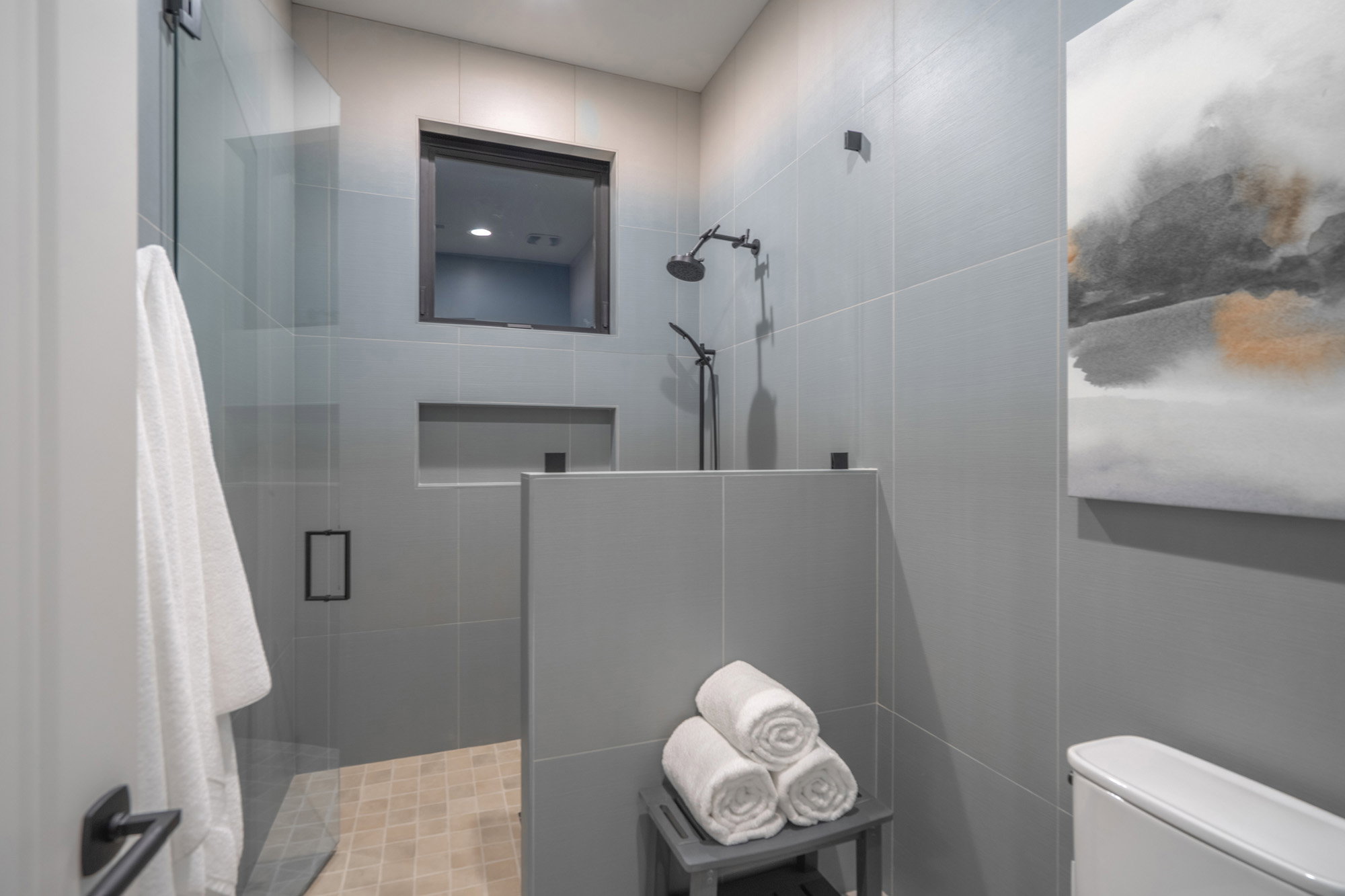 Bathroom with a shower stall and toilet