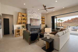 Living room featuring ceiling fan, a fireplace, recessed lighting, and a mountain view