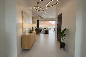Corridor with baseboards and recessed lighting