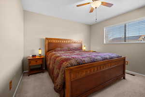 Bedroom featuring ceiling fan and carpet flooring