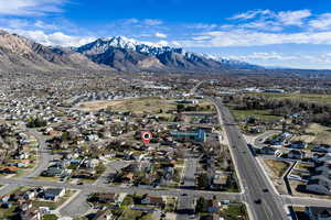 Aerial overview of property's location with nearby suburban area and mountains
