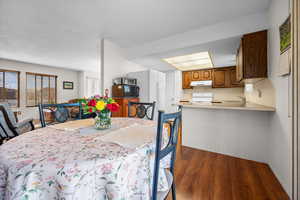Dining space featuring dark wood-style floors
