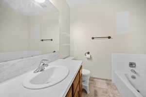 Full bathroom with vanity and a garden tub