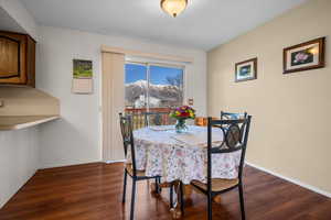 Dining area featuring dark wood-type flooring