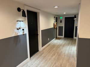 Hall featuring light wood-style floors and recessed lighting