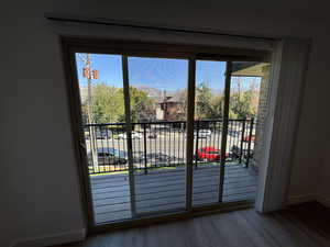 Entryway with baseboards and wood finished floors