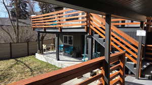Wooden deck featuring a patio area and stairway