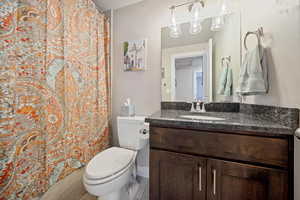 Full bathroom with vanity and curtained shower