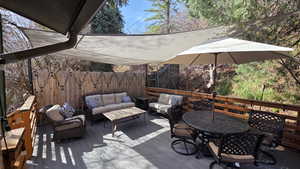 Deck with an outdoor living / dining area