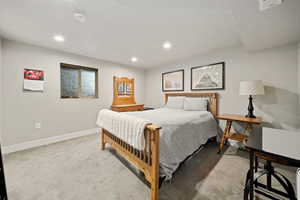 Bedroom featuring light colored carpet and recessed lighting
