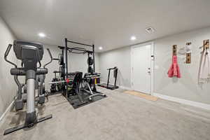 Workout area featuring light colored carpet and recessed lighting