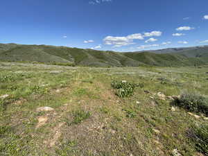 View of mountain backdrop featuring rural landscape