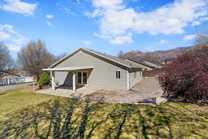 Back of house with a patio, a mountain view, and french doors