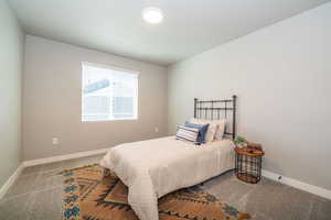 Bedroom with baseboards and carpet flooring