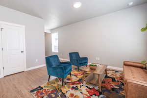 Sitting room featuring wood finished floors and baseboards