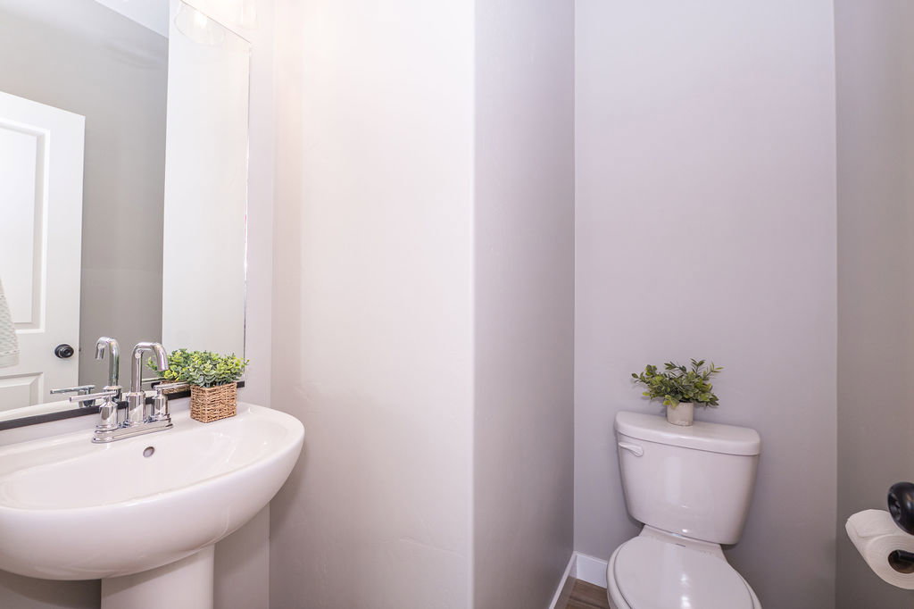 Half bathroom featuring toilet and baseboards