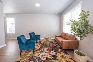 Living area featuring wood finished floors and recessed lighting