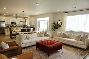 Living room featuring plenty of natural light, light wood-type flooring, and recessed lighting