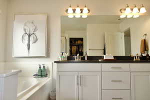 Bathroom with double vanity and a bath