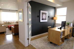 Office space with light wood-style floors and baseboards