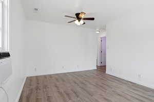 Living room featuring light wood-style floors and ceiling fan