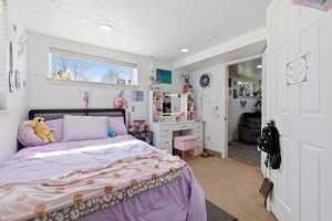 Bedroom with light carpet