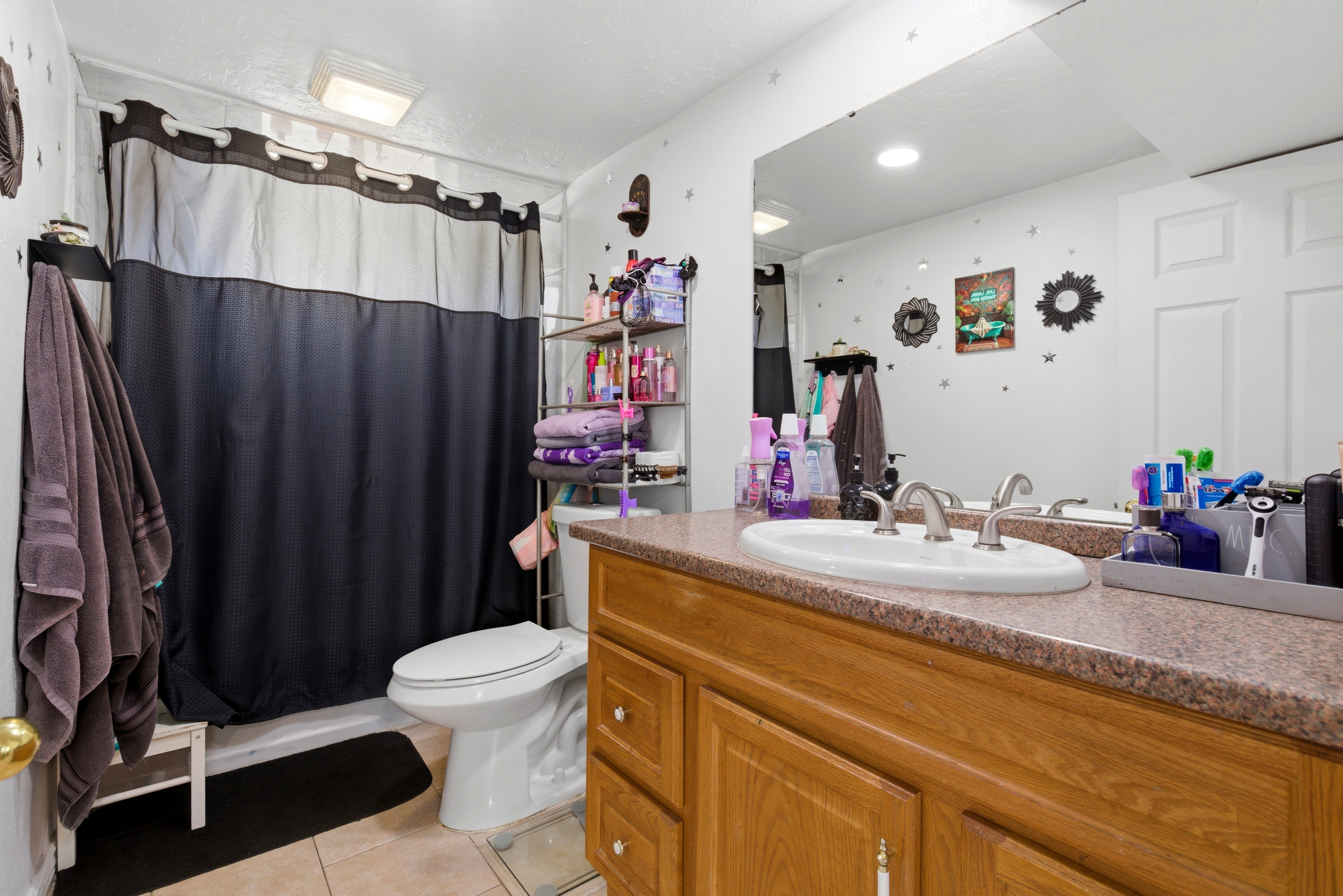 Full bathroom with vanity and light tile patterned flooring