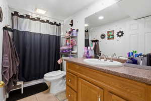 Full bathroom with vanity and light tile patterned flooring