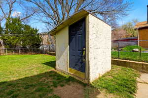 View of shed with a fenced backyard
